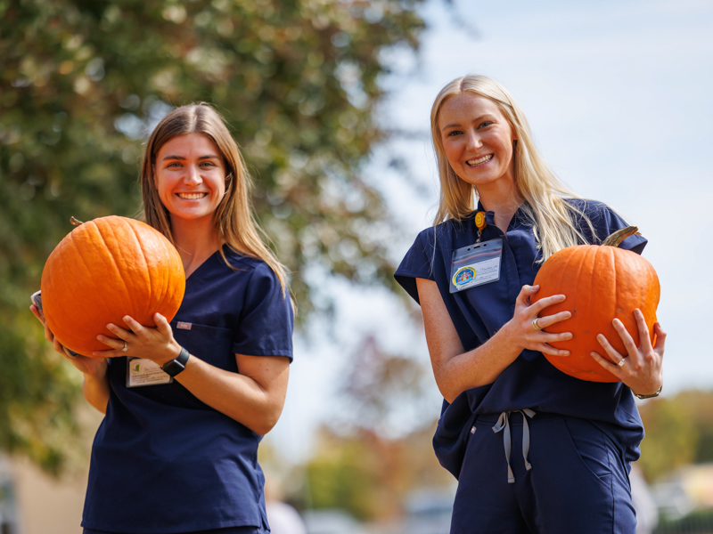 School of Health Related Professions students Mari-Todd Brown, left, and Alice Walker pick their pumpkins.
